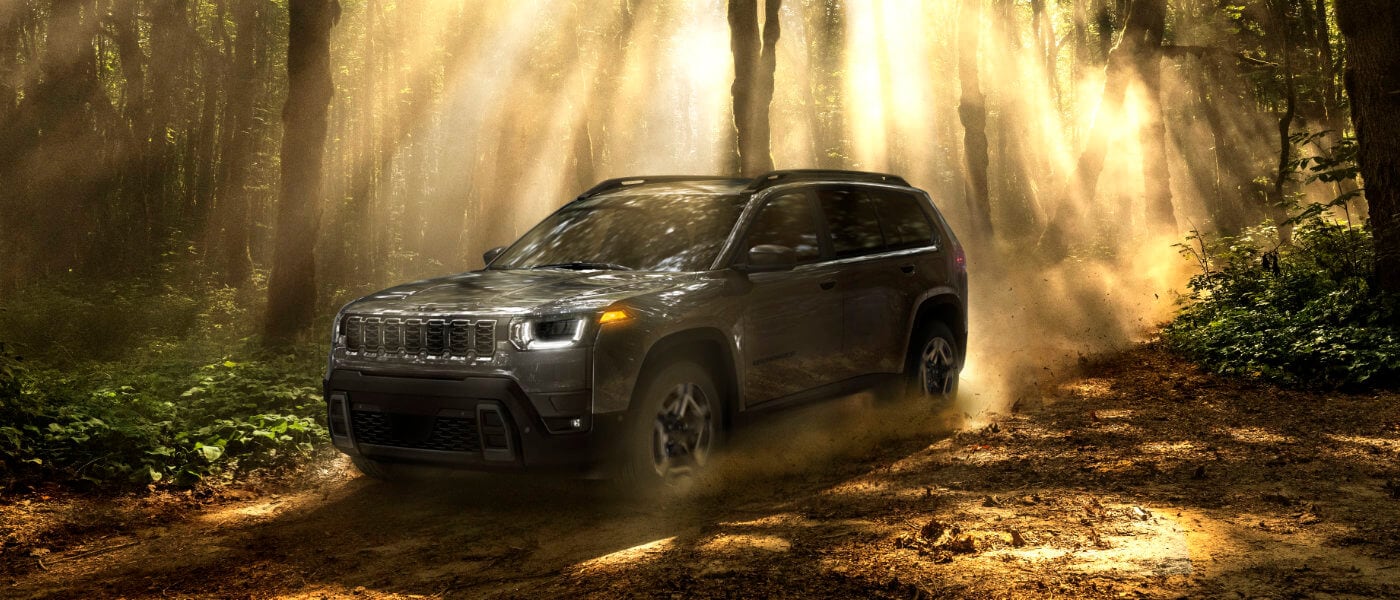 2026 Jeep Cherokee driving on a forest trail