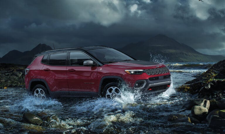 2025 Jeep Compass driving in a stream