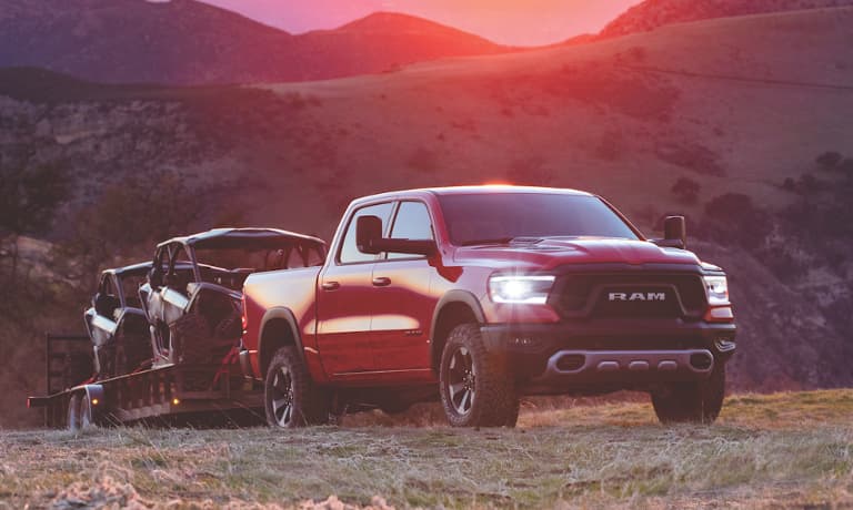 2022 Ram 1500 truck parked on a field during sunset