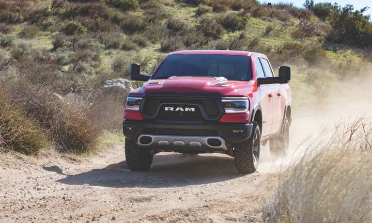 2020 Ram 1500 driving up a dirt hill