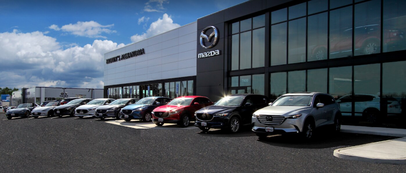 Brown's Alexandria Mazda building with sign and 9 Mazda CX-3 and Mazda CX-5 SUVs lined up in front