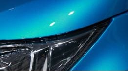 Close-up of a glossy blue vehicle finish and headlamp representing NanoCure exterior appearance protection
