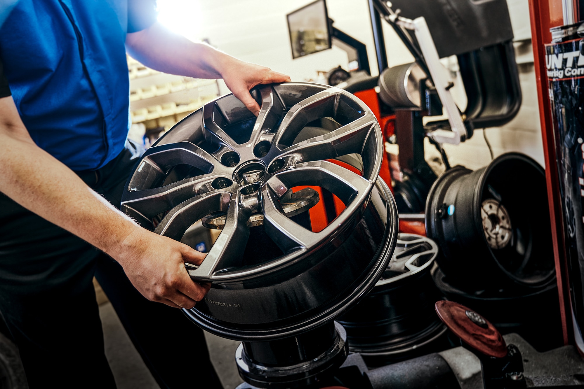 MOPAR technician working on a wheel