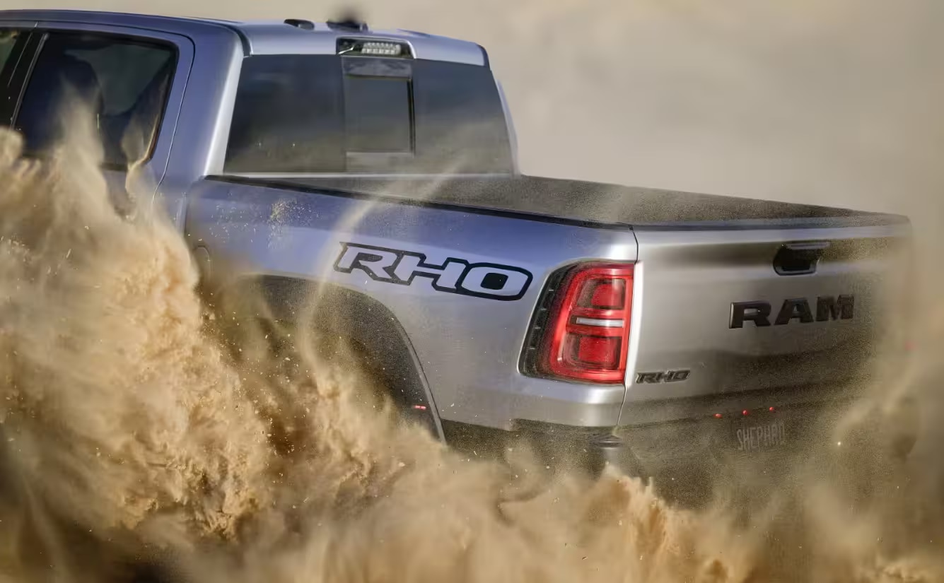 2025-RAM-1500%20RHO-Rugged%20Exterior%20behind.png