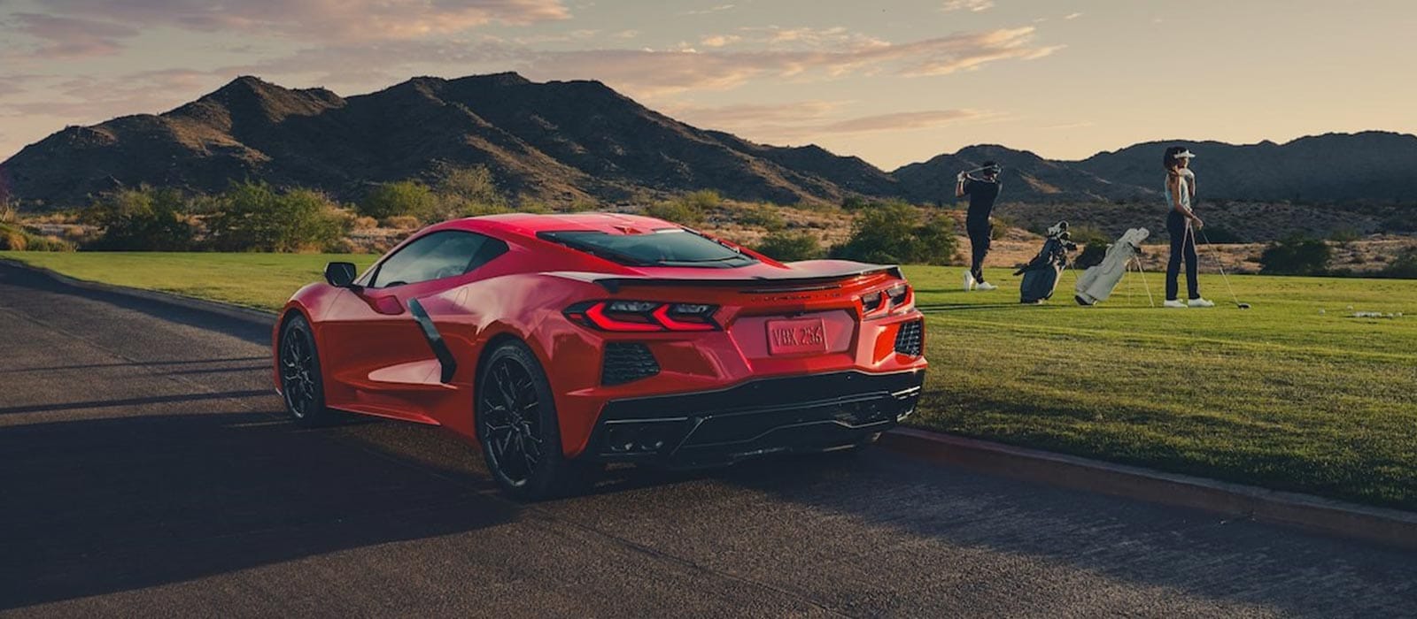 Red 2026 Chevrolet Corvette Stingray parked by a golf course
