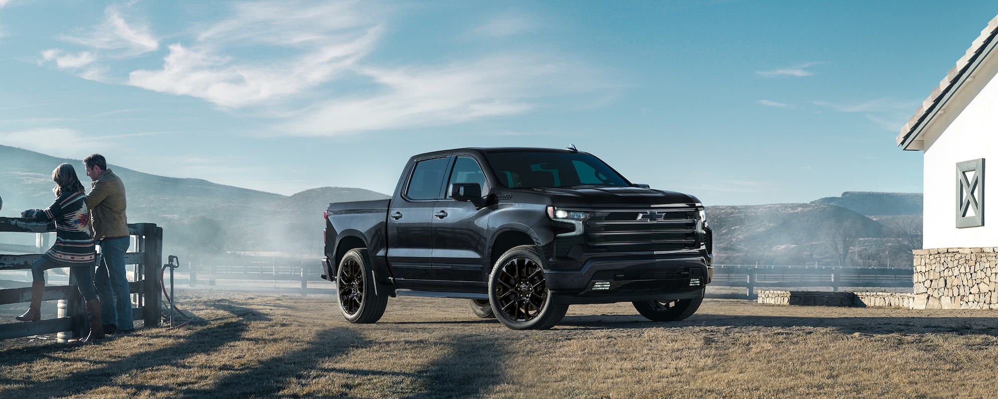 A black Chevy Silverado parked on a ranch