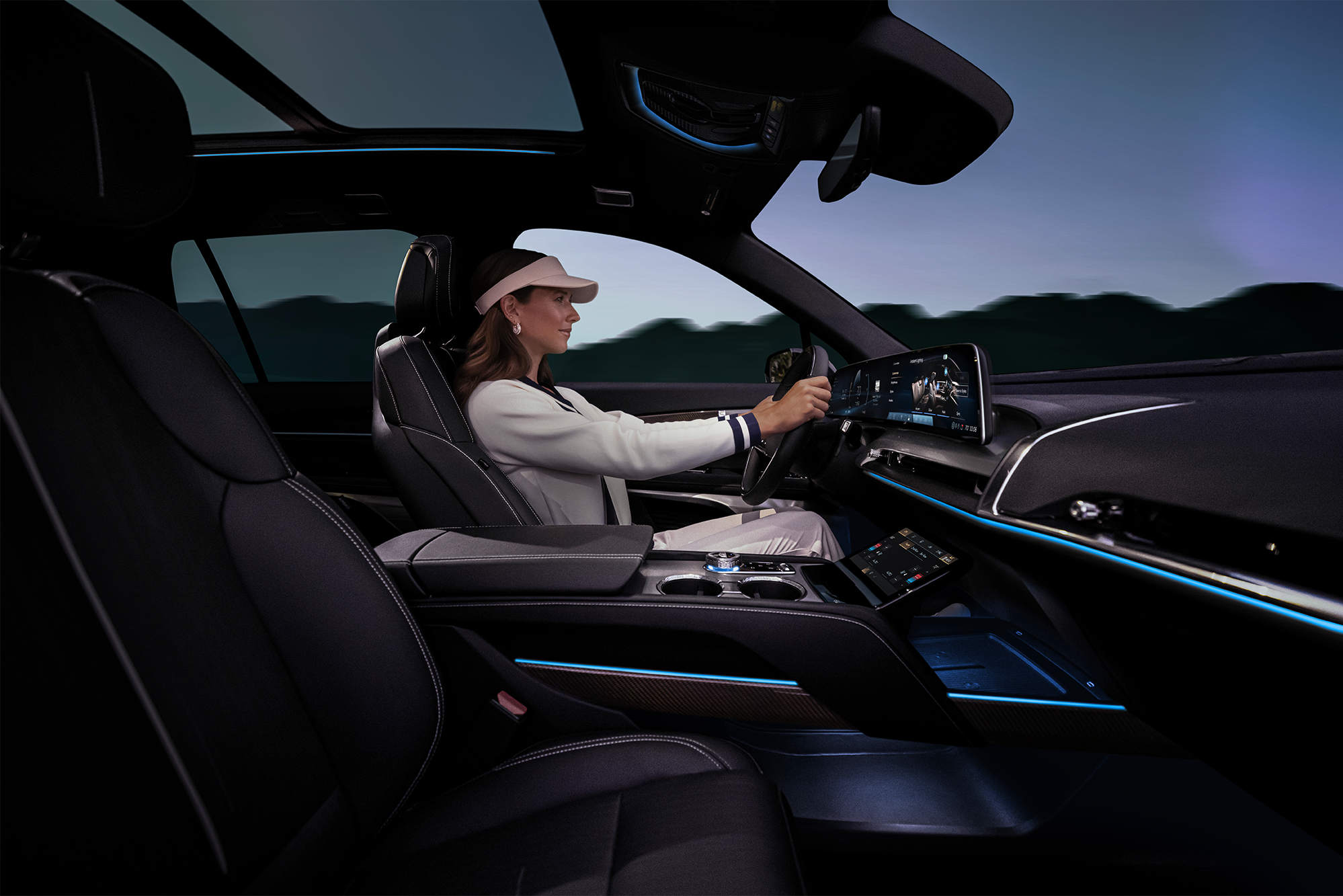 Passenger Side View of a Woman Driving the 2026 Cadillac VISTIQ Luxury Electric SUV 