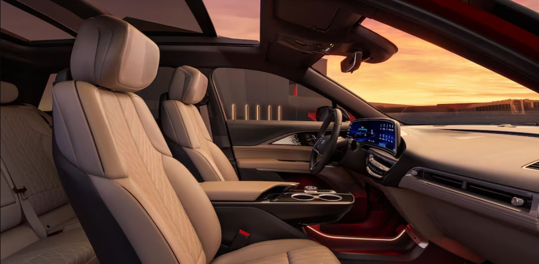 Interior of a 2024 Cadillac LYRIQ. A sunset is visible through the windshield