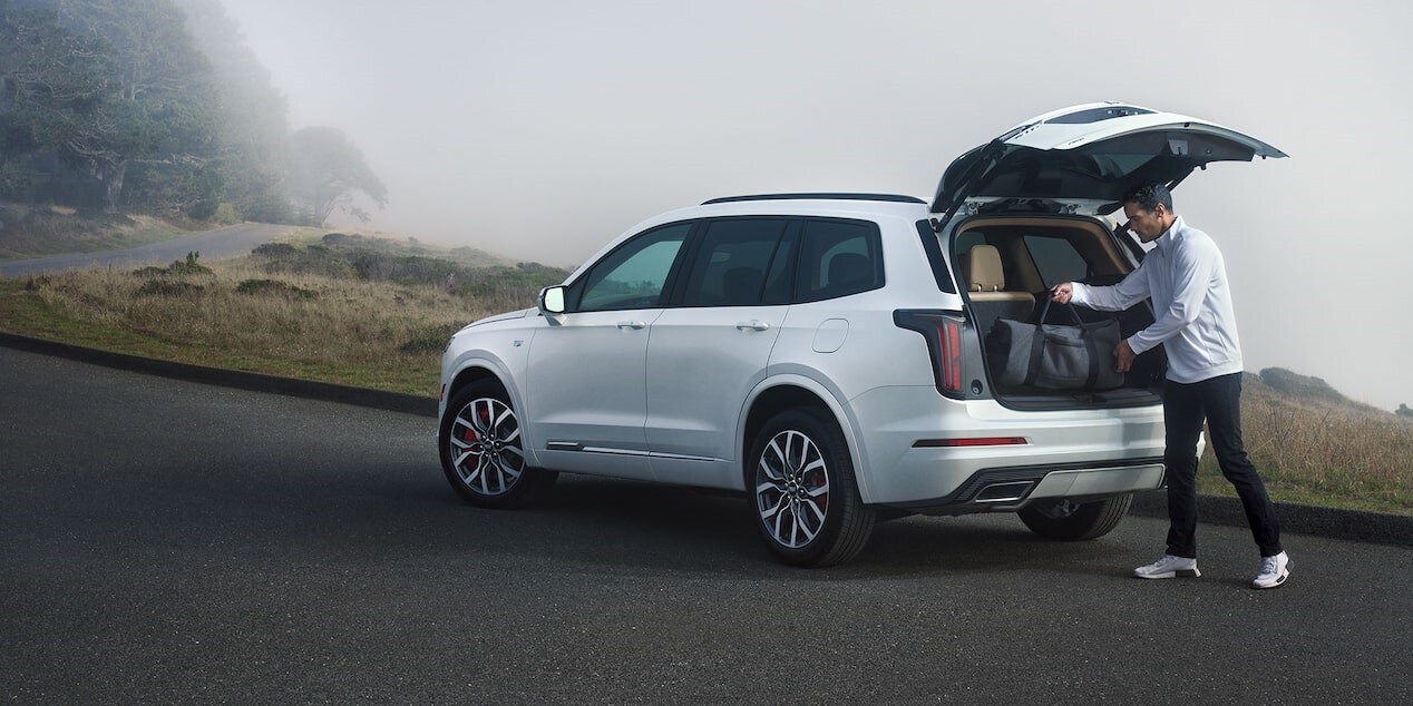 Man loading the back of his new Cadillac XT6