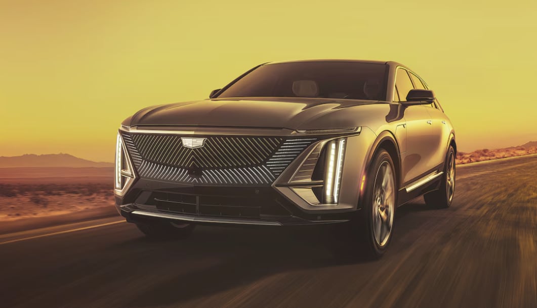 The 2024 Cadillac LYRIQ driving on a road in a desert landscape