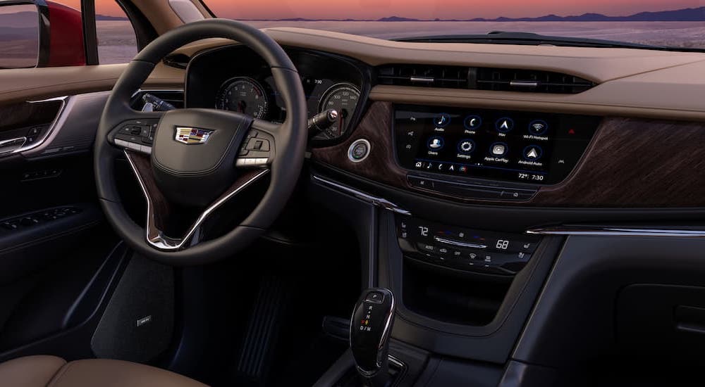 The brown interior of a 2024 Cadillac XT6 is shown from above the center console.