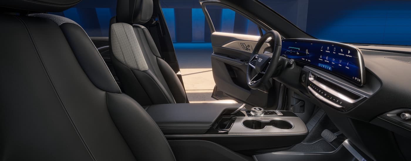 The grey interior of a 2024 Cadillac Lyriq is shown from the passenger side.