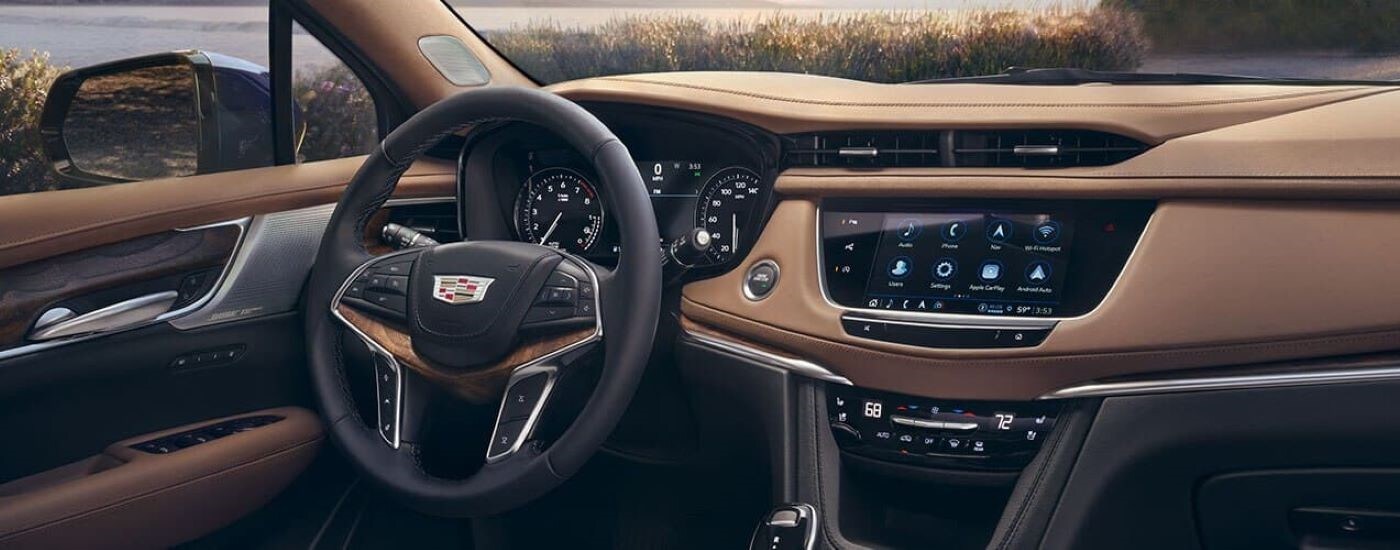 The brown and black interior and dash is shown in a 2024 Cadillac XT5.