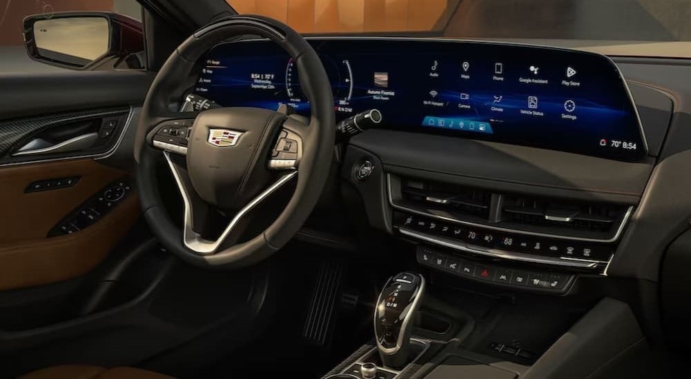 The black and brown interior and dash in a 2025 Cadillac CT5 is shown.