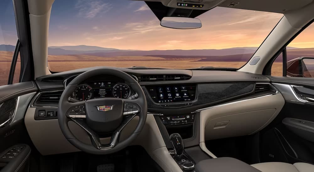 The black and tan interior and dash are shown in a 2025 Cadillac XT6 for sale in New York City.