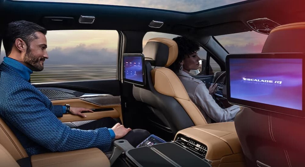 The black and tan rear seat interior is shown in a 2025 Cadillac Escalade IQ.