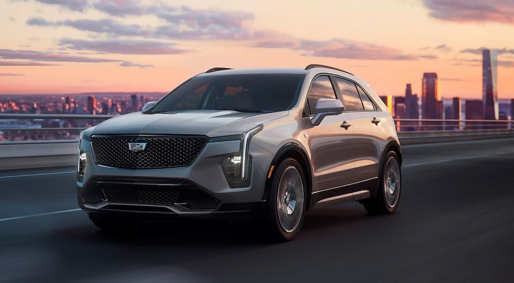 2024%20Cadillac%20XT4%20Luxury%20-%20City%20Scape.jpg A silver 2024 Cadillac XT4 Luxury is shown driving on a highway.