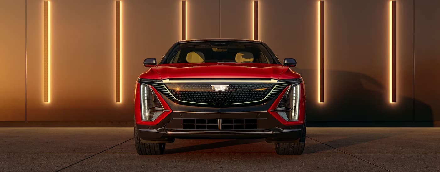 A red 2024 Cadillac Lyriq is parked at a Cadillac dealer near Englewood.