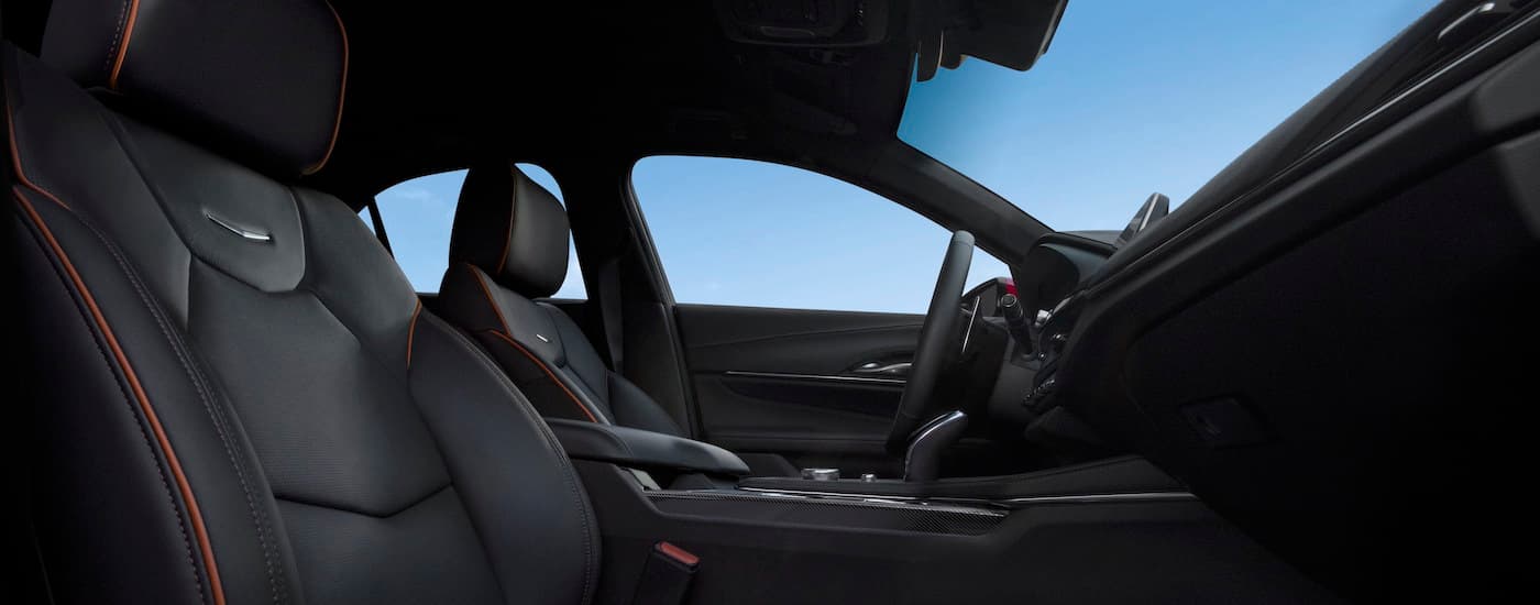 The black and orange interior of a 2024 Cadillac CT4-V is shown from the passenger side.