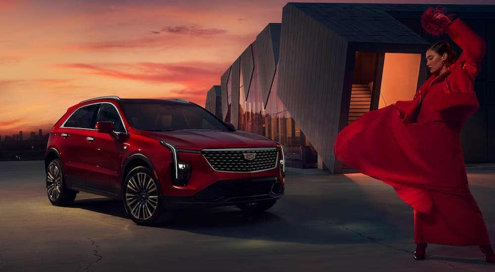 A red 2024 Cadillac XT4 is shown next to a woman dancing.