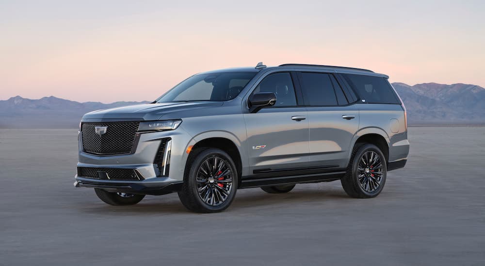 A grey 2024 Cadillac Escalade V is shown from the side after leaving a dealer that has a Cadillac Escalade for sale.