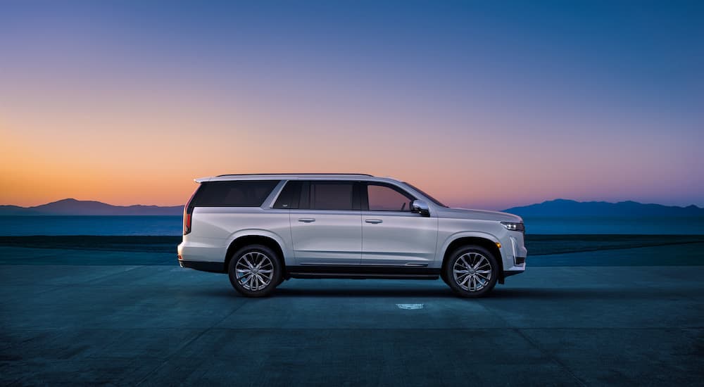 A white 2024 Cadillac Escalade ESV is shown from the side.