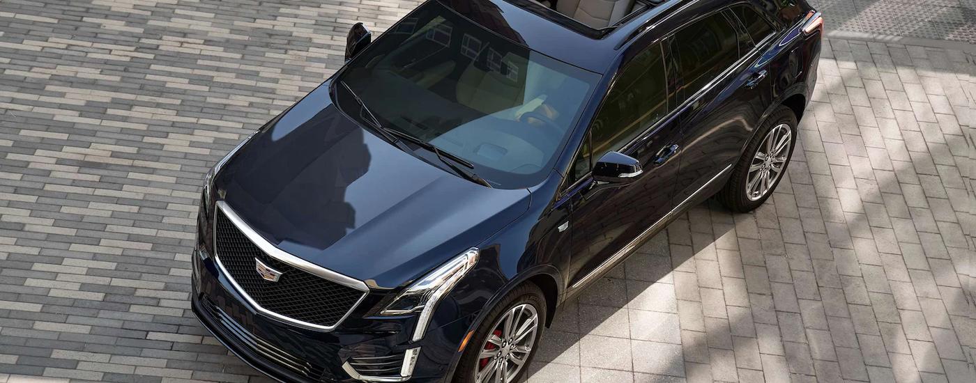 A dark blue 2023 Cadillac XT5 is shown from above after leaving a Cadillac dealer near you.