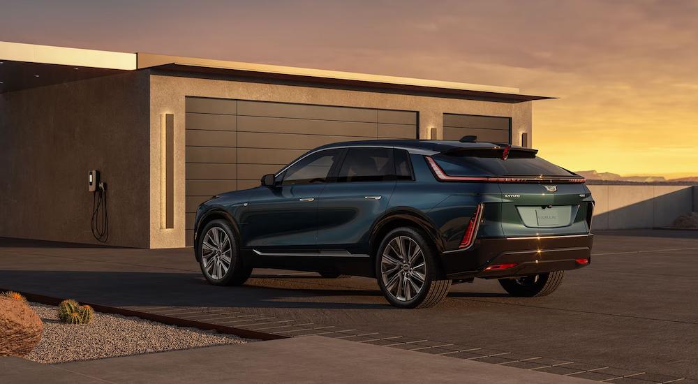 A green 2023 Cadillac LYRIQ is shown parked in a driveway.