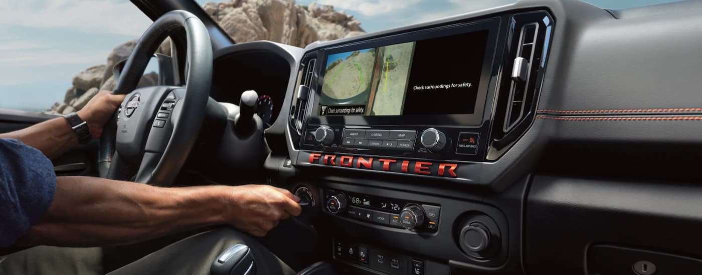 Man driving in a 2026 Nissan Frontier for sale near Ocean Springs
