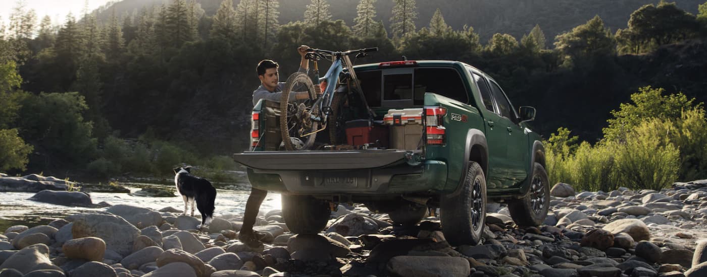 A green 2022 Nissan Frontier parked off-road for sale near Hurley