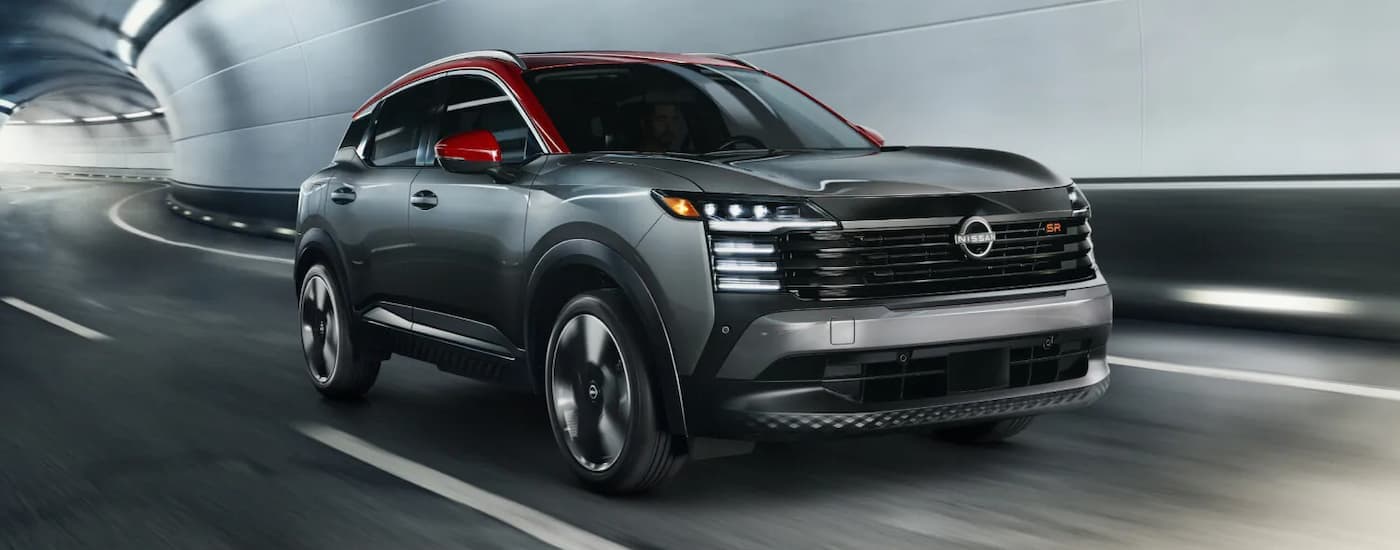 Grey 2025 Nissan Kicks for sale near Pascagoula driving through a tunnel.