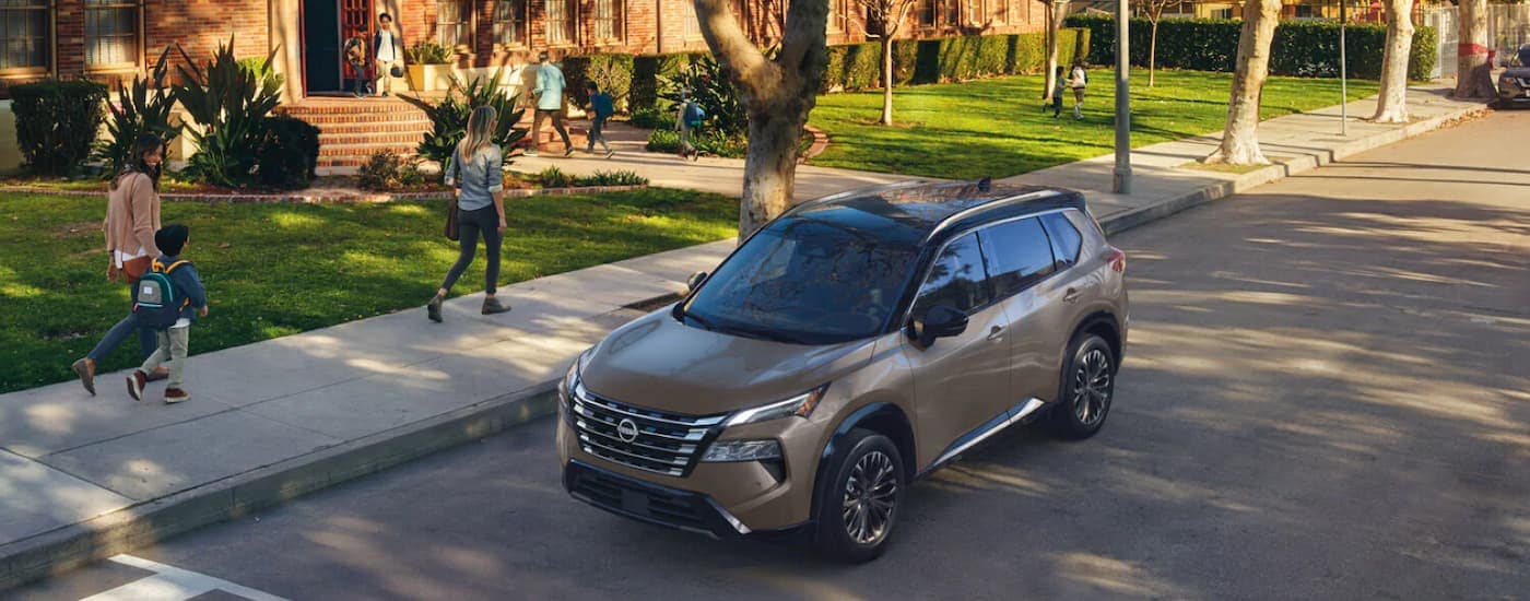 Brown 2025 Nissan Rogue parked on the side of a street