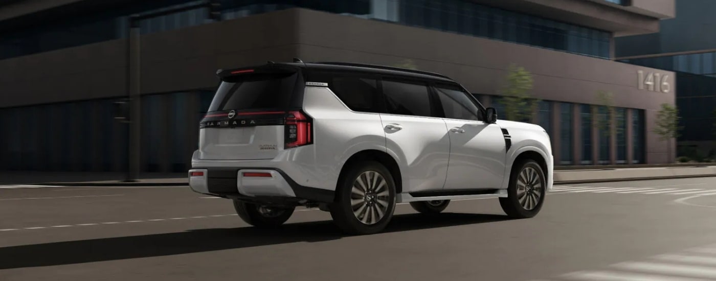 A white 2025 Nissan Armada from the side after leaving a Nissan dealer near Hurley. 