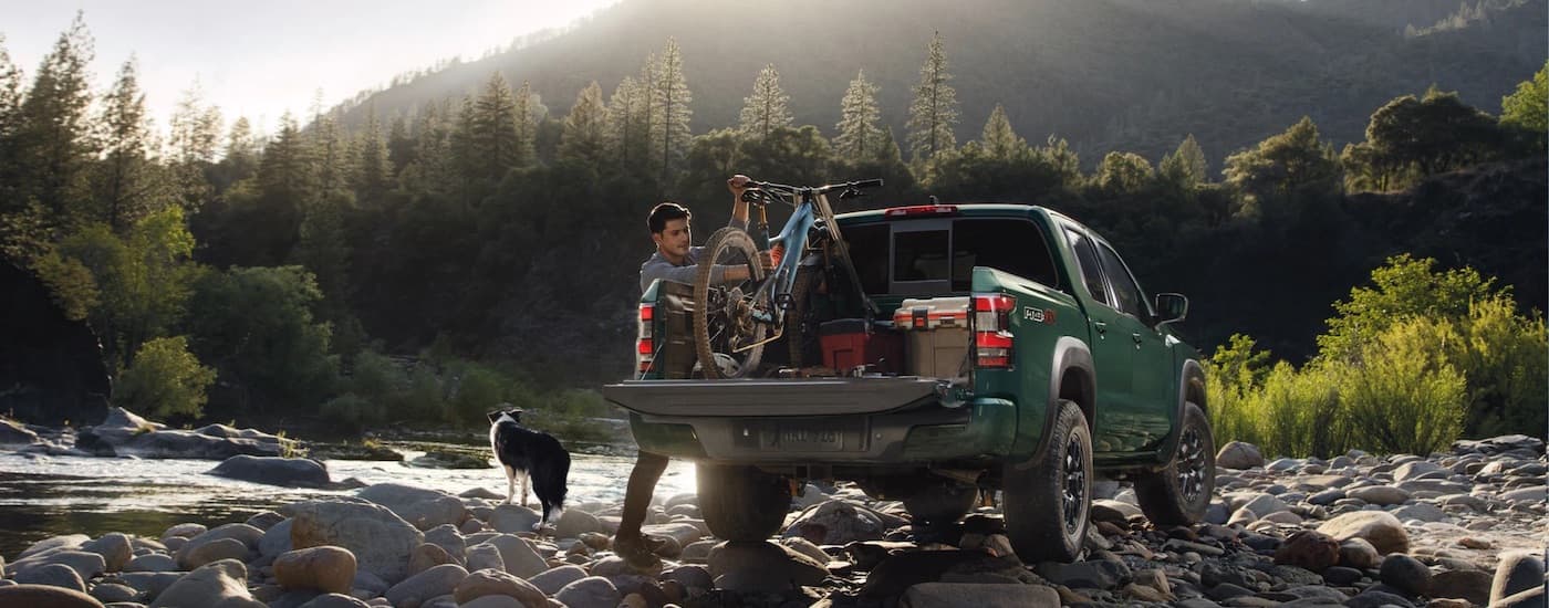 A green 2025 Nissan Frontier Pro-4x parked off-road.