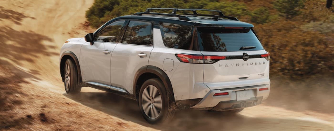 A white 2022 Nissan rogue from the rear at an angle.