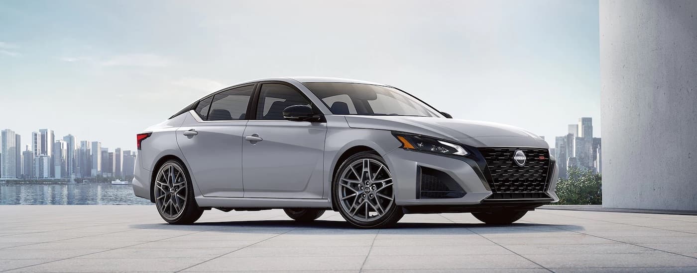 A grey 2024 Nissan Altima from the side after leaving a Nissan dealer near Biloxi.