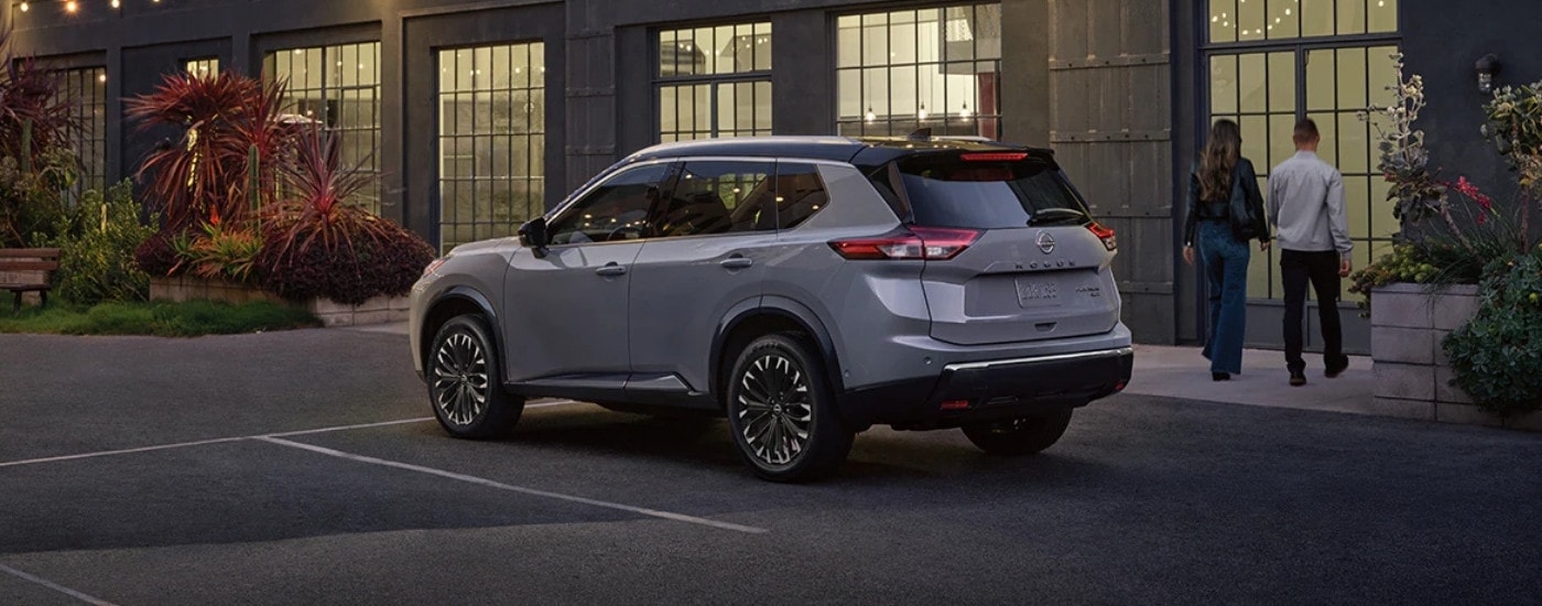 A grey 2025 Nissan Rogue from the rear at an angle.