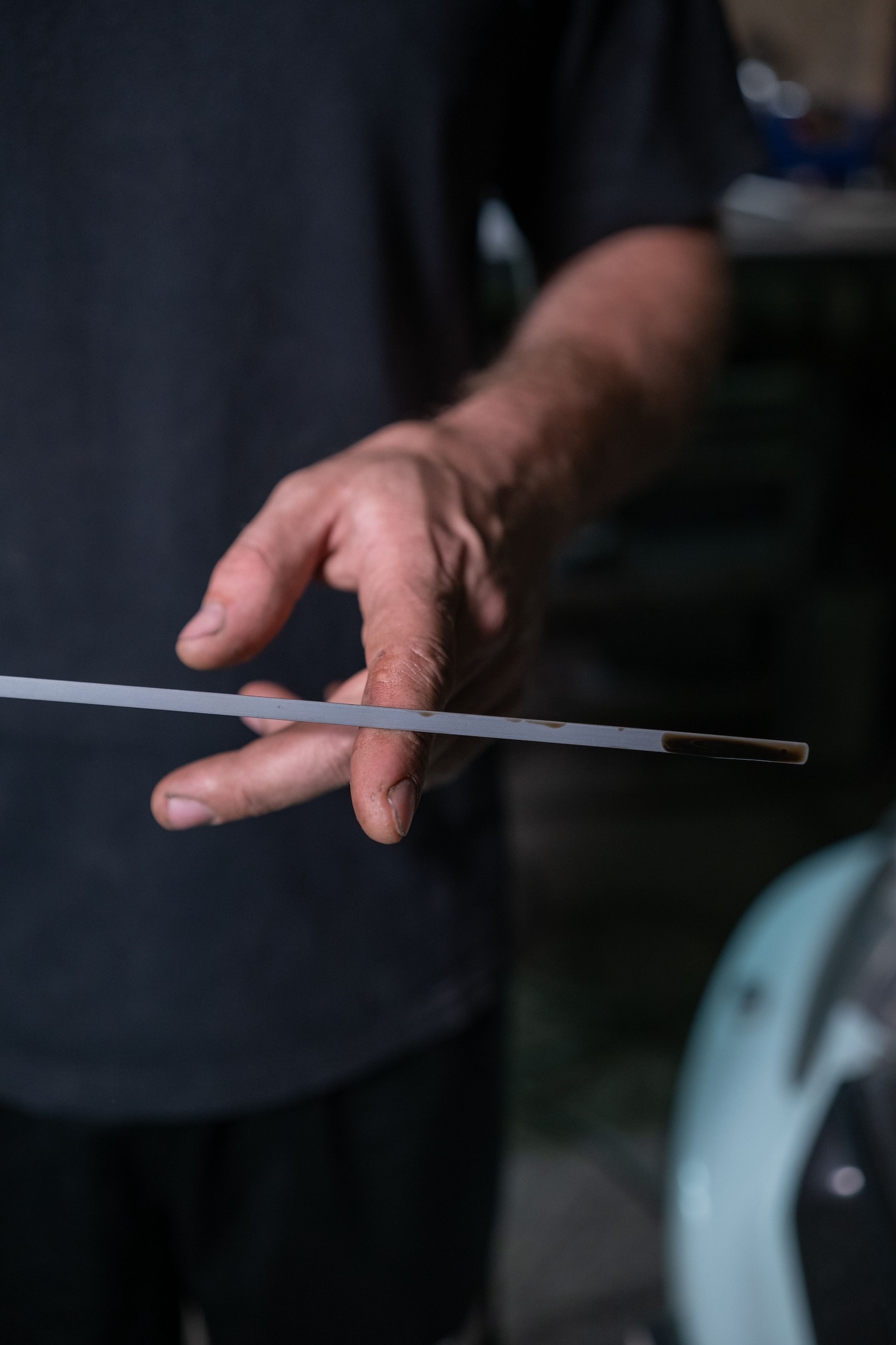 A man changing the oil in a Lincoln car