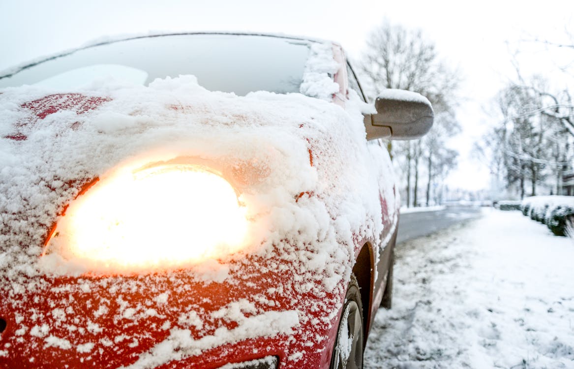 photo of a car driving in the winter snow.jpeg