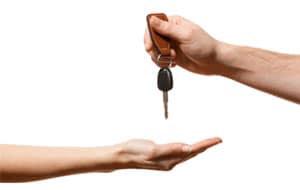 Person grabbing keys to their new leased vehicle