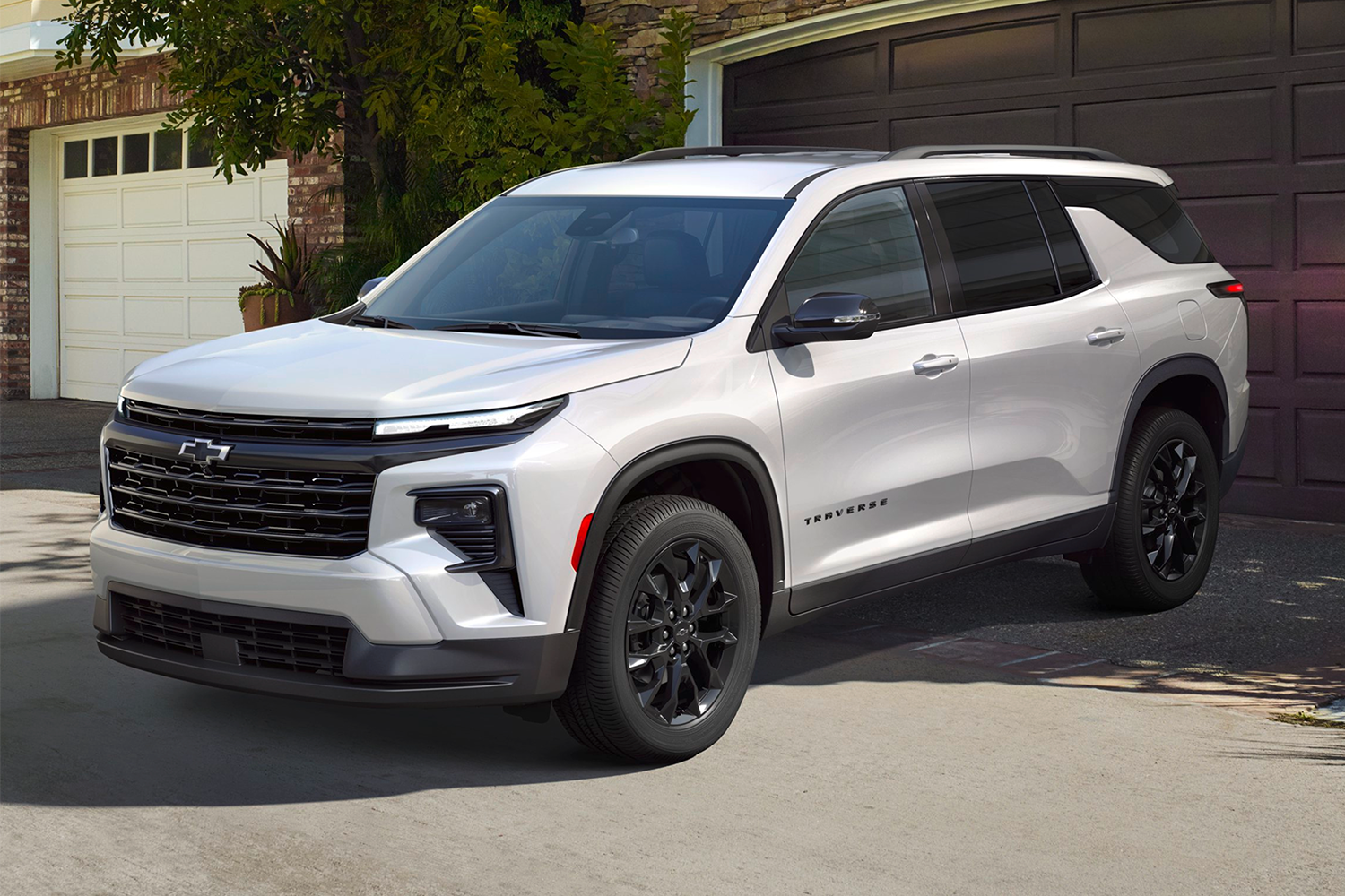 A silver Chevrolet Traverse parked in a driveway