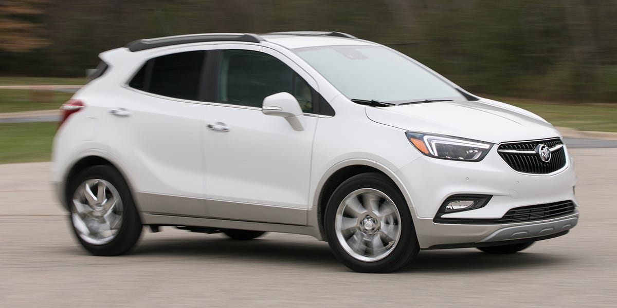 A white Buick Encore driving quickly on the road
