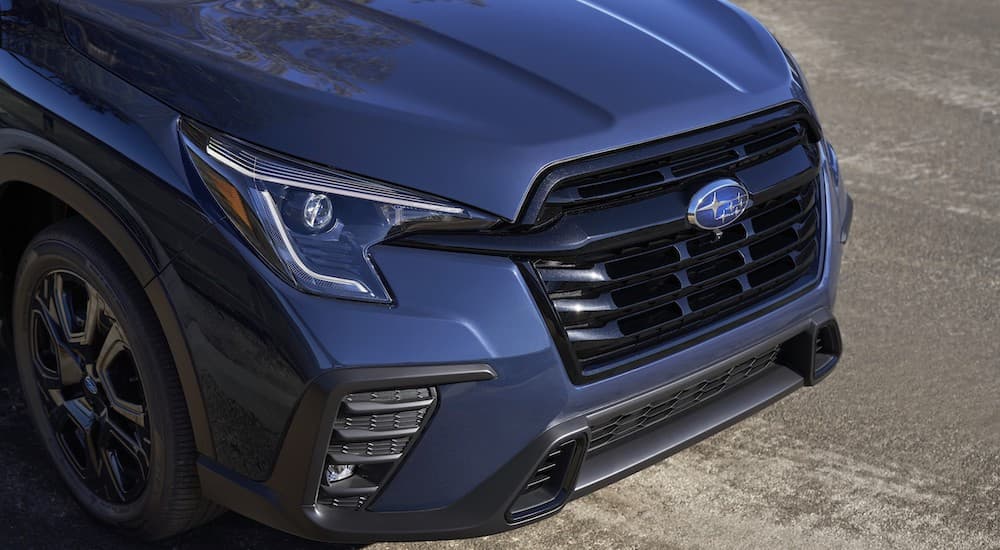 A close up shows the front end of a dark blue 2023 Subaru Ascent.