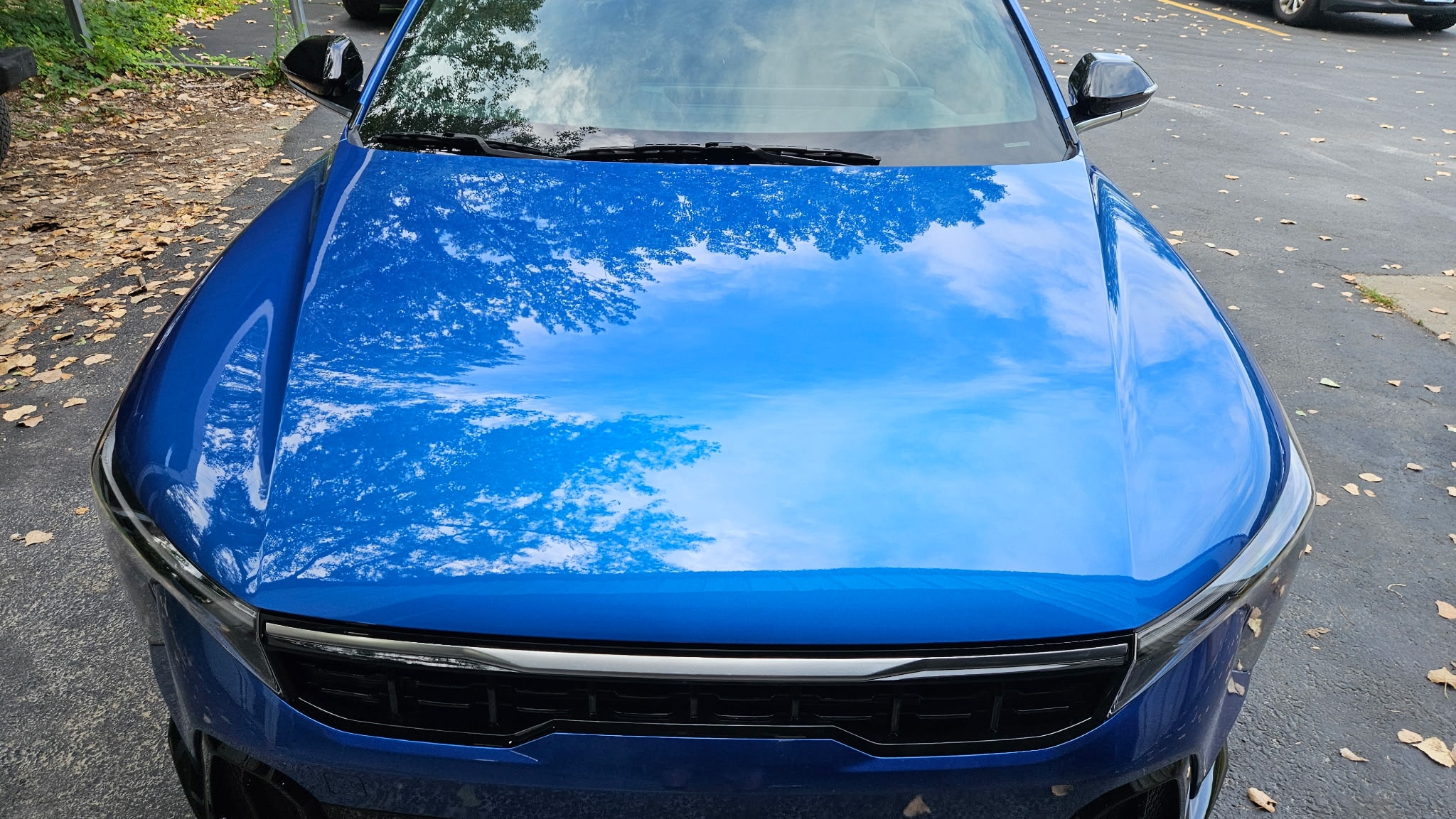 A technician inspecting a vehicle at Car City Wholesale in Shawnee, KS