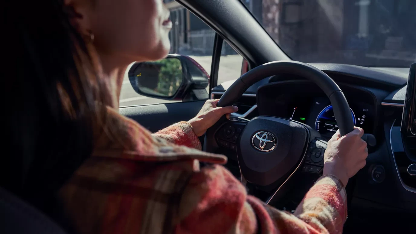 Woman driving a Corolla