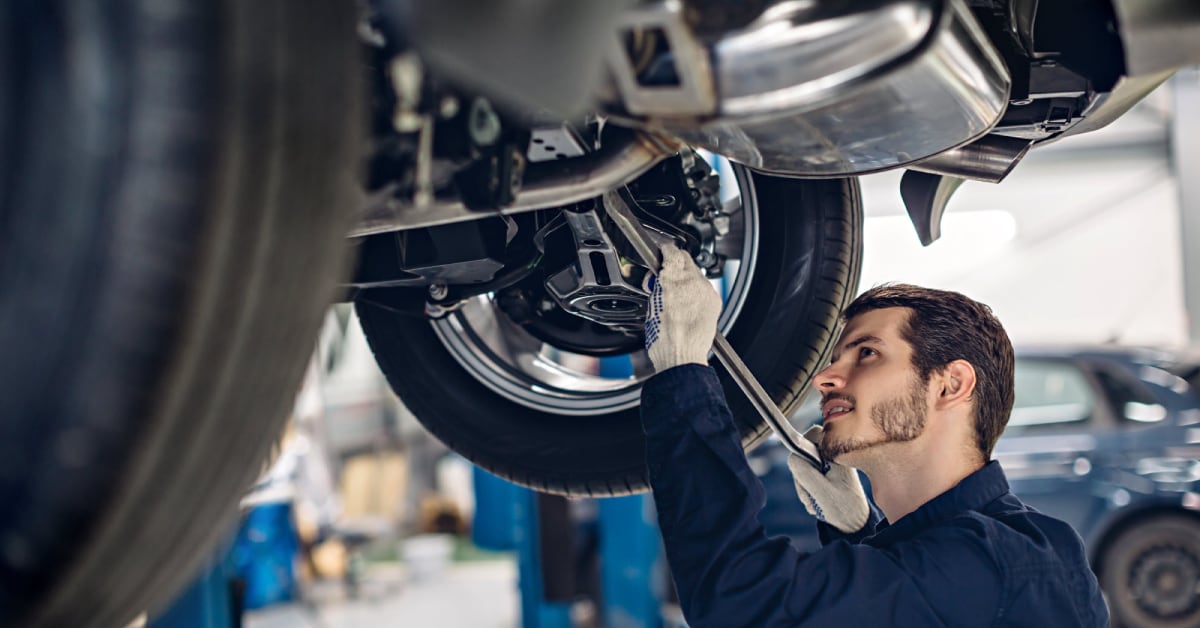 a%20mechanic%20fixing%20the%20underside%20of%20a%20car.jpg