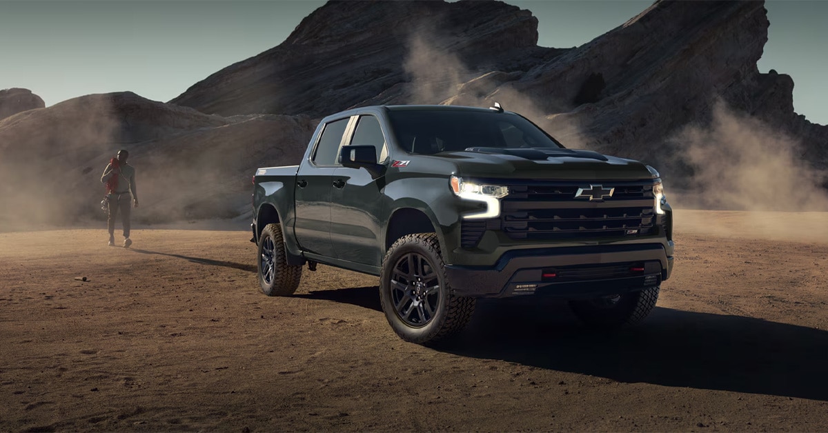 A%20man%20walking%20toward%20a%202026%20Chevrolet%20Silverado.jpg