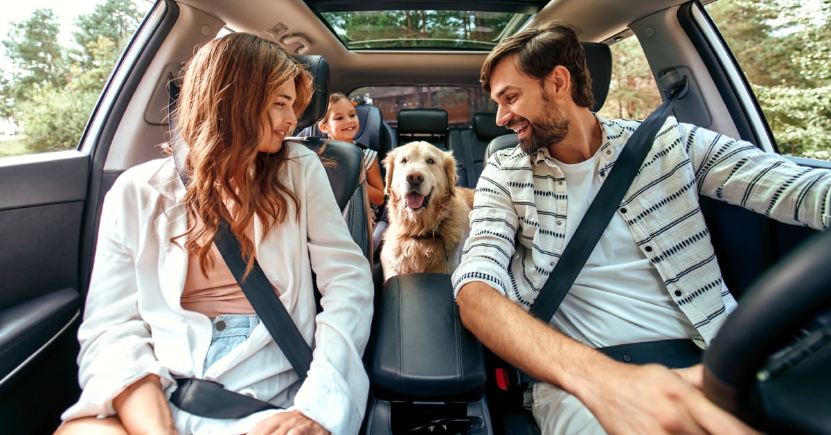 a%20family%20and%20their%20dog%20sitting%20in%20a%20car.jpg