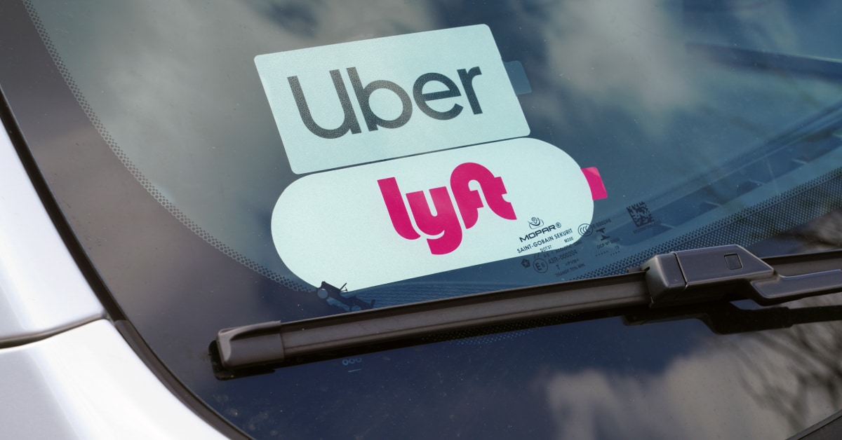 View%20of%20a%20car%20with%20stickers%20for%20both%20the%20Uber%20and%20Lyft%20ride%20share%20service%20on%20the%20windshield..jpg