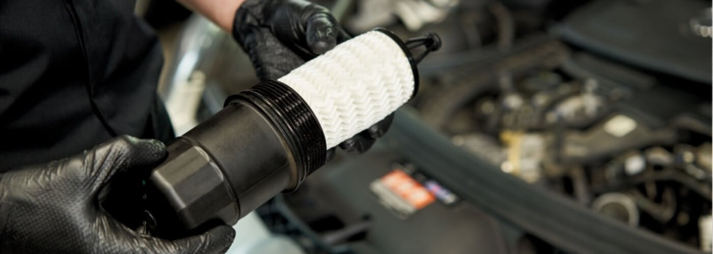 Mechanic holding car part